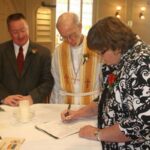 Terry Pochert and Joe Connolly signing their wedding license with Pastor Dick Staats and witness Nancy Nipper